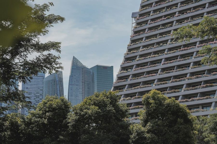 Contemporary condominium facade surrounded by greenery